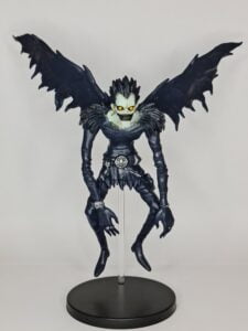 figurine of Ruyk from Death Note, floating and stretched wings, front-facing